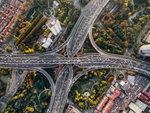 Future mobility concept with electric cars, autonomous vehicles, and smart city transportation systems.