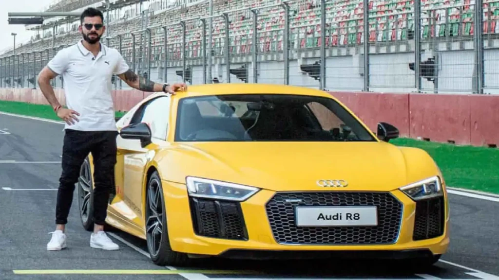 Virat Kohli posing with his yellow Audi R8 V10 Plus sports car.