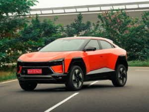 Mahindra BE 6 Sporteq electric SUV in orange on a road